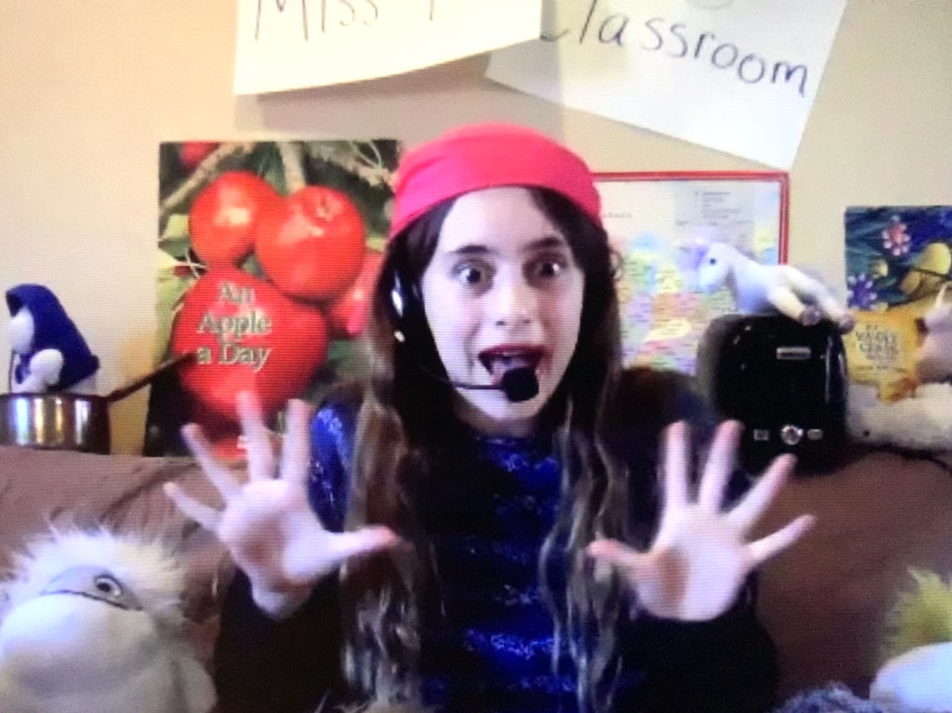 An actor with hands spread wide, smiling crazily