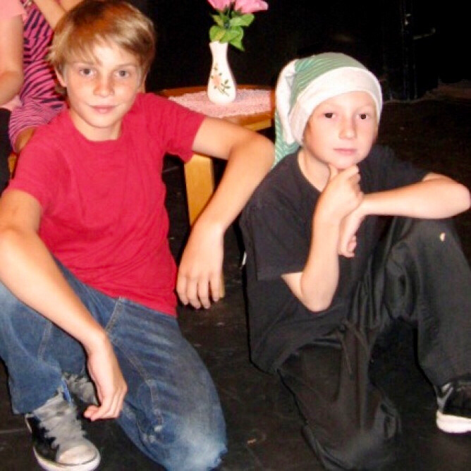 Two actors posing onstage looking cool